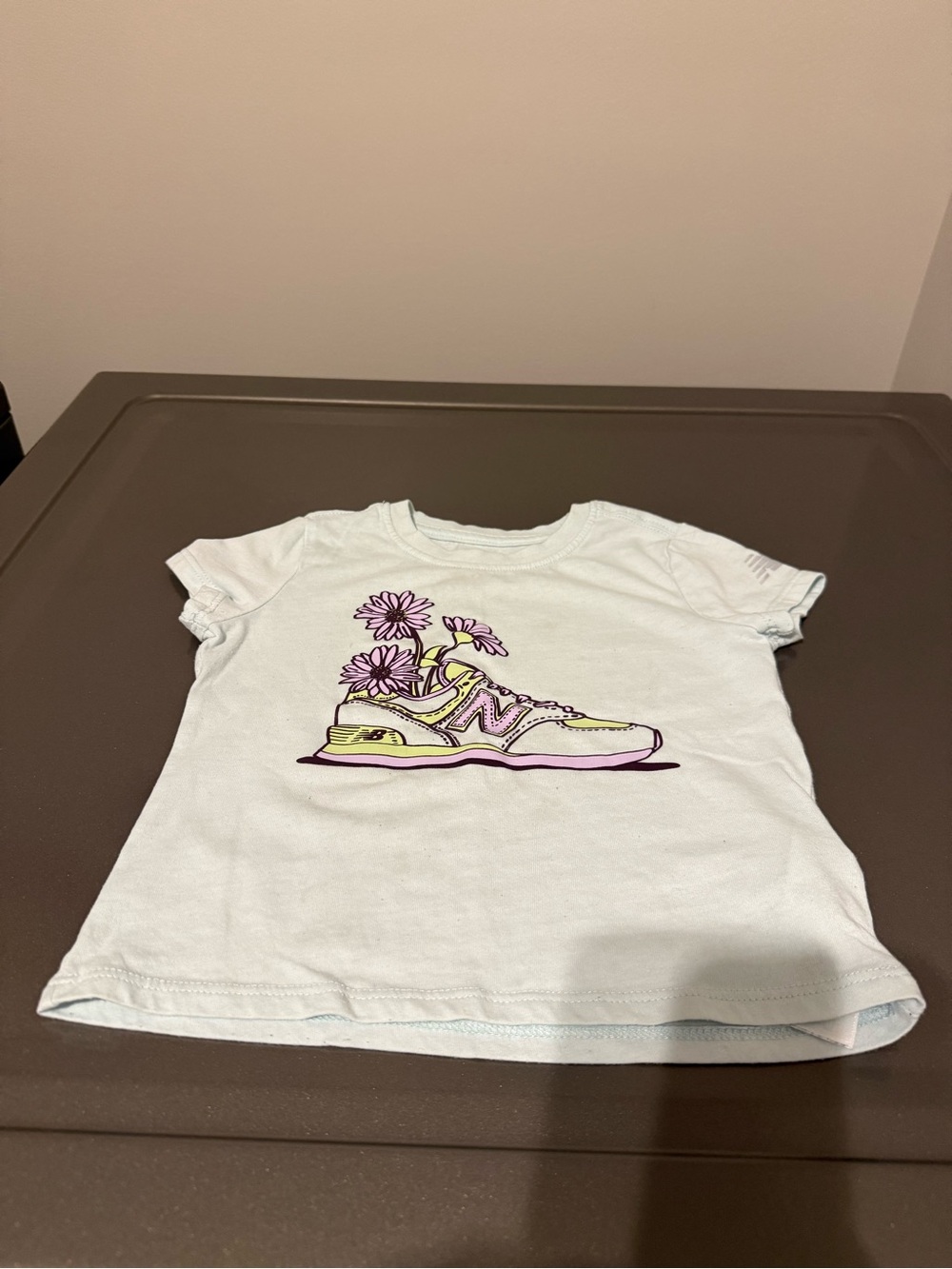 New Balance Kids White Tee with Yellow & Purple Sneaker Graphic